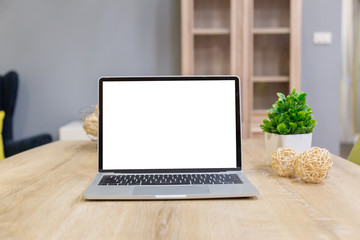 Wall Mural - laptop showing blank screen on work table front view in home- Image