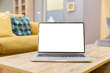 Wall Mural - laptop showing blank screen on work table front view in home- Image