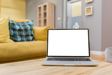 Wall Mural - laptop showing blank screen on work table front view in home- Image