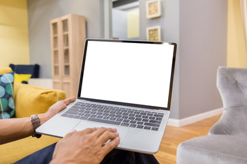 Wall Mural - Mockup image of a businessman using laptop with blank white desktop screen working in home- Image