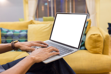 Wall Mural - Mockup image of a businessman using laptop with blank white desktop screen working in home- Image