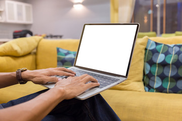 Wall Mural - Mockup image of a businessman using laptop with blank white desktop screen working in home- Image