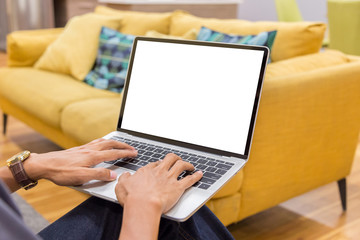 Wall Mural - Mockup image of a businessman using laptop with blank white desktop screen working in home- Image