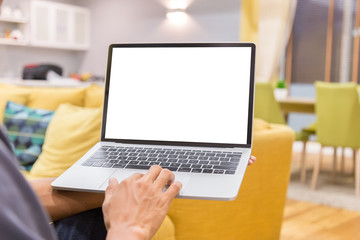 Wall Mural - Mockup image of a businessman using laptop with blank white desktop screen working in home- Image