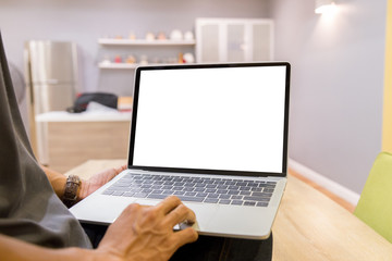 Wall Mural - Mockup image of a businessman using laptop with blank white desktop screen working in home- Image