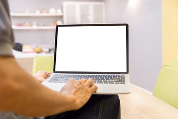 Wall Mural - Mockup image of a businessman using laptop with blank white desktop screen working in home- Image