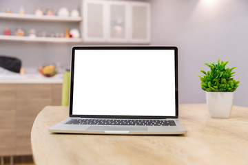 Wall Mural - laptop showing blank screen on work table front view in home- Image