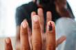 View of the hand of a person who did voting and having the ink mark on his index finger in front of the mirror