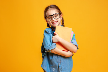 funny child school girl girl on yellow background .