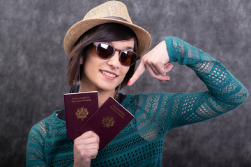 Poster - young woman with summer hat holding passports