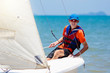 © famveldman - Man sailing. Boy learning to sail on sea yacht.