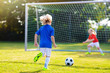 © famveldman - Kids play football. Child at soccer field.
