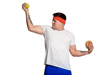 concept man makes the choice between healthy and unhealthy food. the choice between a burger and an apple. will power when dieting. 