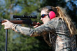 © Daniel Teetor - A woman aiming a rifle.