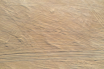 Truck trail on the sand, the ground, aerial view.