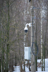  A high-tech surveillance camera shoots us in the winter Park, ensuring our safety.