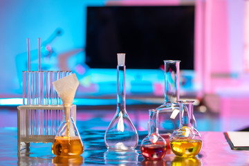 Poster - Laboratory glassware. Flasks for reagents are on the laboratory table. Medical glass vials. Chemical laboratory equipment. Laboratory diagnostics. Chemical synthesis. Biochemistry. Pharmacology.