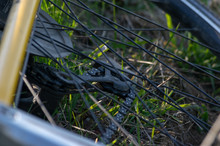 Close Up Shot Of A Rear Derailleur Of A Bicycle Laying In The Grass 
