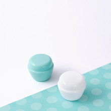 White And Turquoise Cosmetic Bottle Containers With Decor, On White Background Top View Flat Lay.