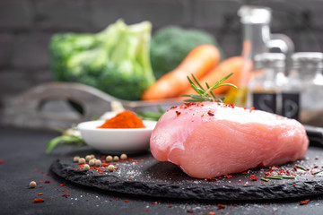 Fresh raw turkey meat fillet with ingredients for cooking