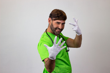 Wall Mural - Portrait of male veterinary doctor in green uniform with brown hair holding up eight fingers, their back facing the camera and looking at the camera. Isolated on white background.