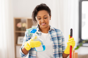 Sticker - cleaning, housework and housekeeping concept - african american woman or housewife with mop and detergent sprayer at home