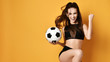 © Dmitry Lobanov - Sporty woman player or fan in black uniform with the soccer ball celebrates happily a win and gesticulate actively