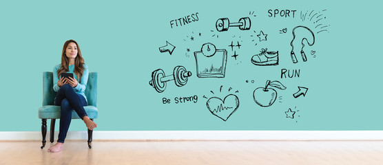 Wall Mural - Fitness and diet with young woman holding a tablet computer