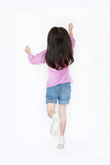 Rear view little kid girl jumping over white background. Freedom kid movement concept.