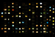 Night Time Lapse Of Light In The Windows Of A Multistory Building. Life In A Big City