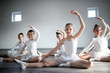 © NDABCREATIVITY - Group of fit happy children exercising ballet in studio together