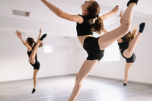 Group Of Fit Happy Children Exercising Ballet And Dancing In Studio Together