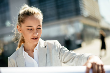 Wall Mural - Architect presenting a new plan. Businesswoman with blueprints.	