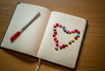 notebook and pen on wooden table