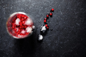 Berry drink with ice on black background