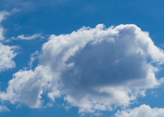 Blue sky on a sunny day with fluffy white and blue clouds.