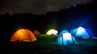 Camp tent illuminated at night under a sky