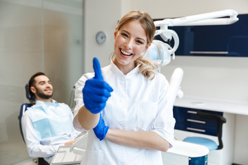 Happy young woman doctor in medical dentist center.