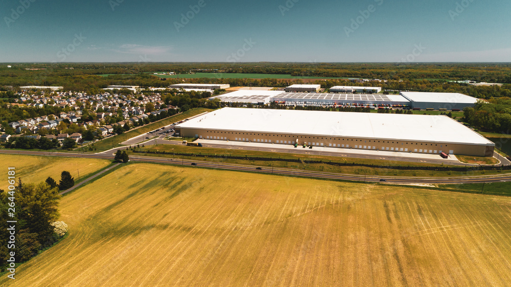 Rural Suburban Farm Land with Woods and Giant Warehouse Aerial Drone View