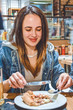 © Vlada - One young girl sits in cafe and has dinner.