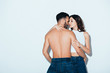 © LIGHTFIELD STUDIOS - pretty young woman embracing shirtless boyfriend on grey