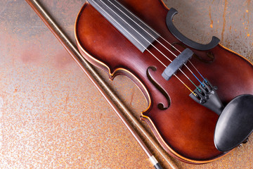 Classical violin on rusty background. Studio shot of old violin. Classical musical instrument