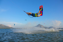 Young Male Tourist Jumping And Doing Tricks While Kitesurfing In Sunny Greece.