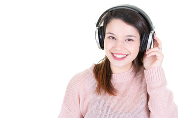 Wall Mural - Studio portrait of adorable happy smiling young woman relaxing in headphones