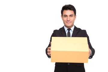 Portrait of a charming businessman dressed in suit holding parcel while standing and looking at camera isolated over white background, Professional of delivery concept