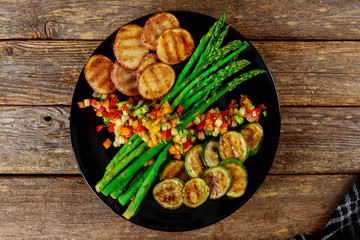 Wall Mural - Dinner plate with grilled asparagus, green zucchini, salad, potatoes and tomato