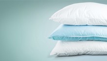 Soft Pillows Pile on grey background, three pillow, sleeping items.