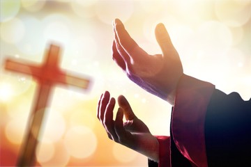 Poster - Hands of human praying on cross bokeh