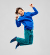 © Syda Productions - childhood, expressions and people concept - portrait of smiling boy in blue hoodie jumping over grey background