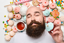 Happy Bearded Man Biting Cream Cake Isolated On White Background